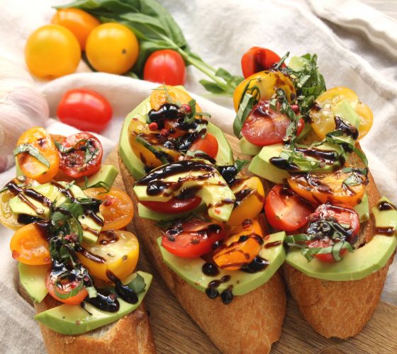 Bruschetta com abacate, tomates e redução de balsâmico